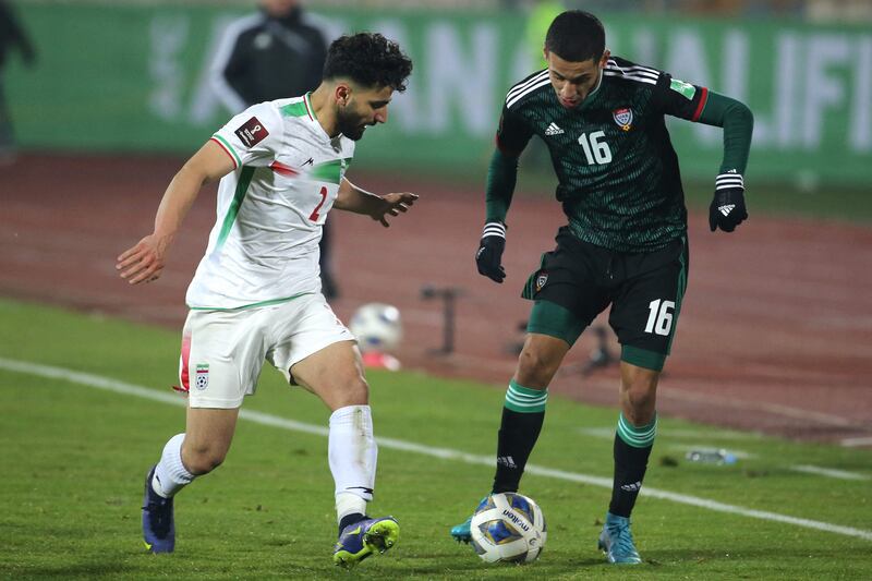 UAE forward Ali under pressure from Iran defender Sadegh Moharrami during the World Cup Asian Qualifier at the Azadi Sports Complex in Tehran, on February 1, 2022. AFP