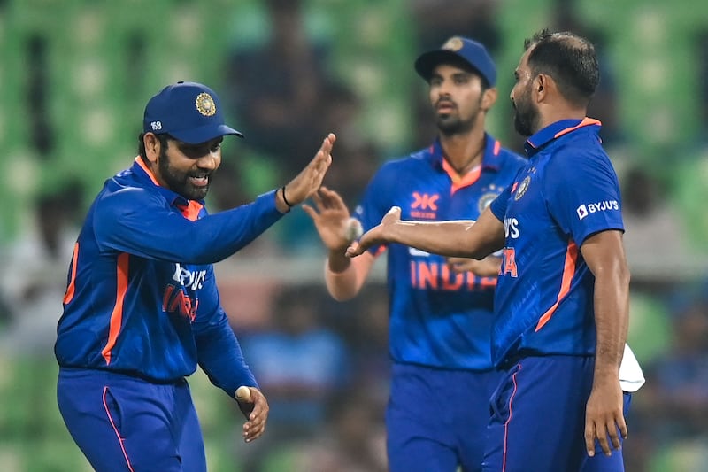 Mohammed Shami (R) celebrates after taking the wicket of  Charith Asalanka. AFP