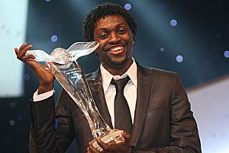 Emmanuel Adebayor holds the African Footballer of the Year award at the Emirates Palace.