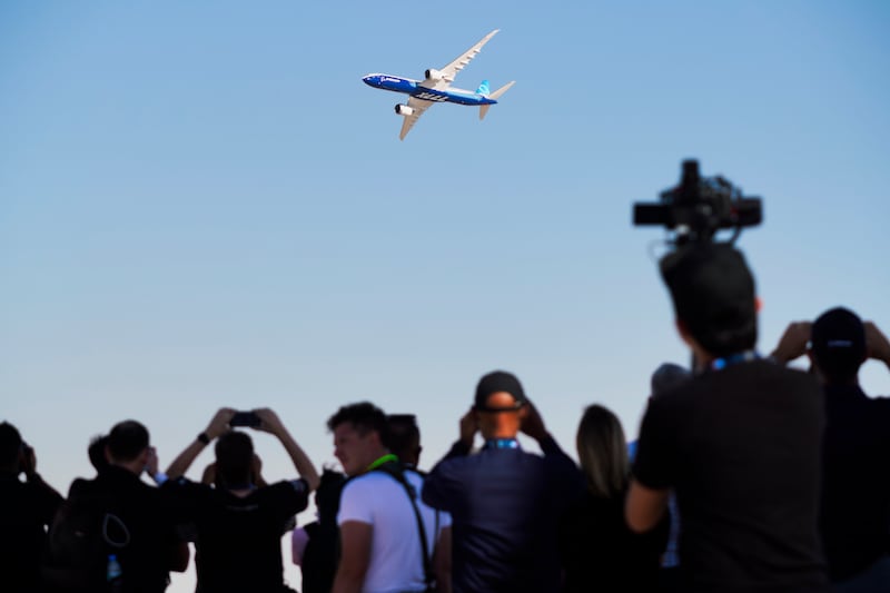 A crowd watches a Boeing 777X fly at the Dubai Airshow. AP Photo