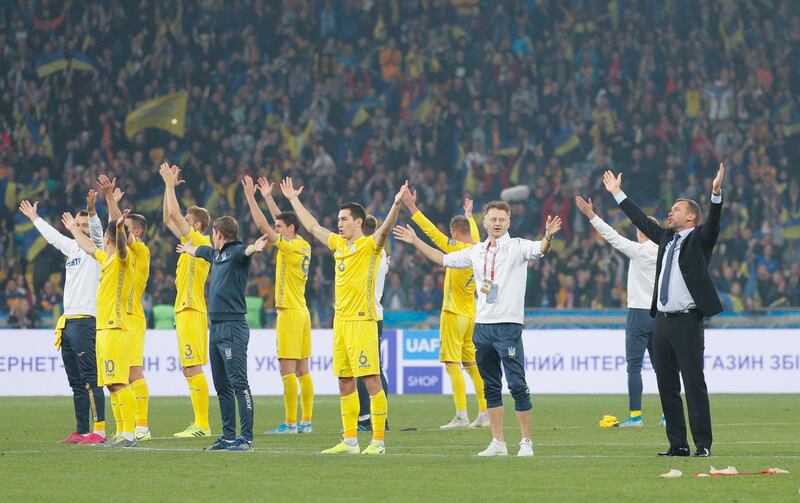 Ukraine players together with head coach Andriy Shevchenko, right, thank their fans after beating Portugal 2-1 in Kiev to seal their spot at Euro 2020. EPA