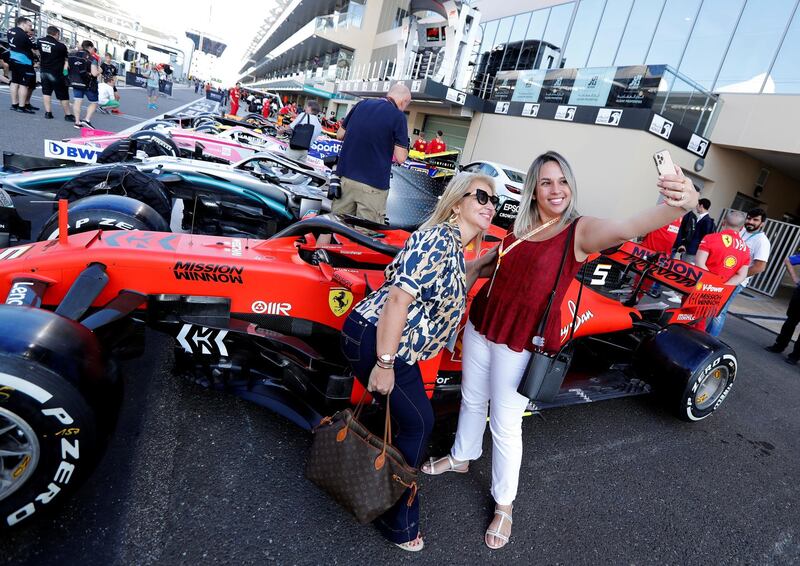 Fans take a selfie with the cars ahead of the Abu Dhabi Grand Prix. Reuters