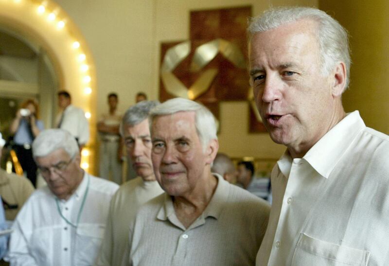 US Senator Richard Lugar of Indiana (C) and Chuck Hagel of Nebraska (2nd L) listen on as Joe Biden of Delaware (R) speaks to the press at a  hotel in Baghdad 23 June 2003. The congressional delegation is touring the capital and attending official meetings. AFP PHOTO/Marwan NAAMANI (Photo by MARWAN NAAMANI / AFP)