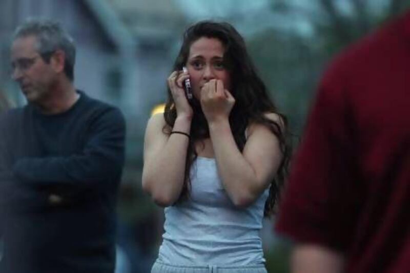 Rosie Meyer reacts to the police activity in her neighbourhood after a manhunt for the men suspected of setting off bombs at the Boston Marathon centred near her home in Watertown, Massachusetts. Mario Tama / Getty Images / AFP