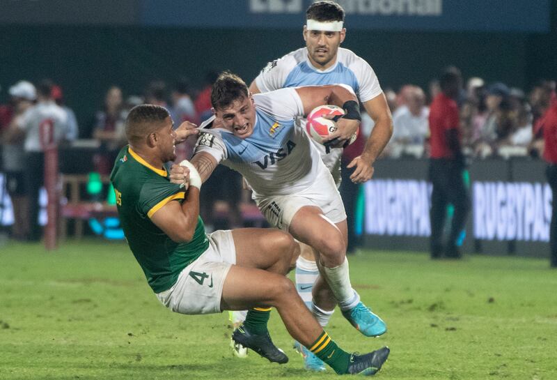 An Argentina player is tackled.