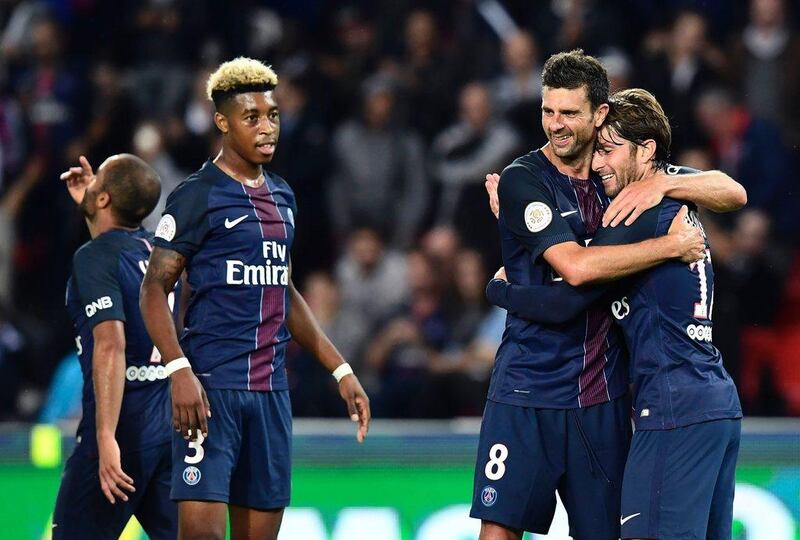 Paris Saint-Germain's Maxwell, right, celebrates after a goal with Thiago Motta, centre, and Presnel Kimpembe. Miguel Medina / AFP / September 20, 2016