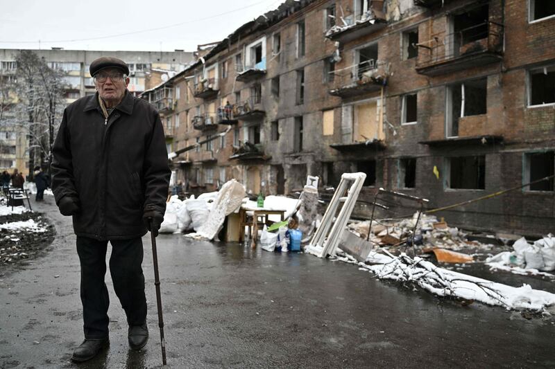An elderly man walks in front of a residential building damaged following a  missile attack in Vyshgorod. AFP