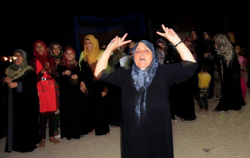 Relatives celebrate during the arrival of freed Palestinian prisoner Ateya Abu Moussa, who was held by Israel for 20 years, upon his arrival at his family's house in Khan Younis in the southern Gaza Strip, early on August 14, 2013. Israel freed 26 Palestinian prisoners on August 14, hours before the two sides were to hold new direct peace talks amid a growing row over settlements.      AFP PHOTO / SAID KHATIB
 *** Local Caption ***  734269-01-08.jpg