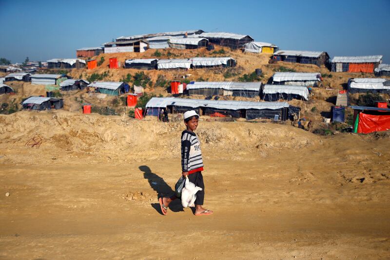 A Rohingya refugee boy walks to his shelter after returning from the market with a chicken in Balukhali refugee camp near Cox's Bazar, Bangladesh. Navesh Chitrakar / Reuters