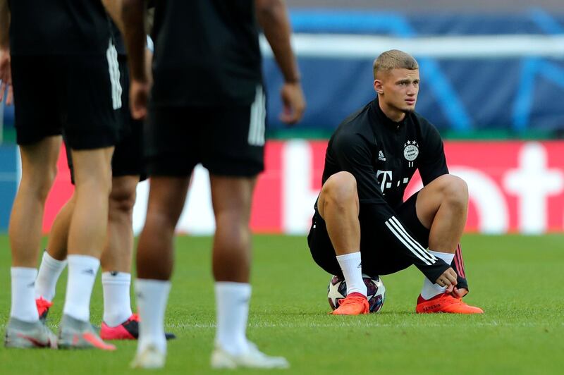 Bayern's Mickael Cuisance ties his boots during a training session. AP