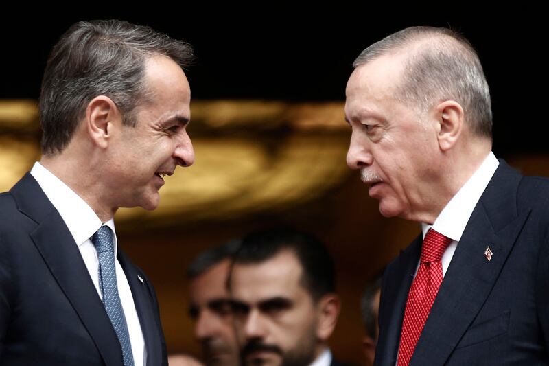 Mr Mitsotakis and Mr Erdogan talk after their meeting. EPA