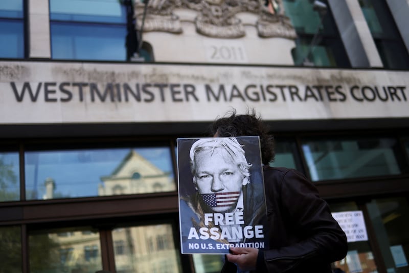 A Julian Assange supporter outside Westminster Magistrates' Court in London. A British magistrate has sent the case of Julian Assange to Home Secretary Priti Patel who will decide whether the Wikileaks founder should be extradited to the US.  Reuters