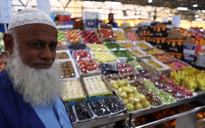 A stall holder in Dubai with produce ready for Ramadan. EPA