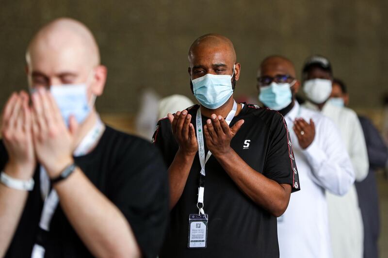 Muslim pilgrims, clad in face masks due to the COVID-19 coronavirus pandemic, pray after throwing pebbles as part of the symbolic al-A'qabah (stoning of the devil ritual) at the Jamarat Bridge during the Hajj pilgrimage in Mina.   AFP