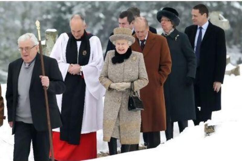 Queen Elizabeth II and her husband Prince Philip arrive at the church of St Peter and St Paul at West Newton, in eastern England, yesterday. The 85-year-old monarch braved the cold and snow to attend the Sunday service on the eve of the Diamond Jubilee of her reign.