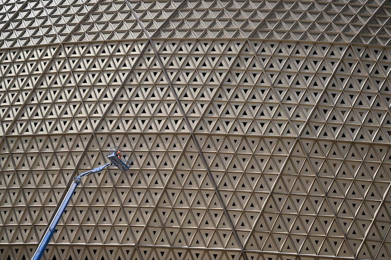 A man works on the facade of the Lusail Stadium in Doha. AFP