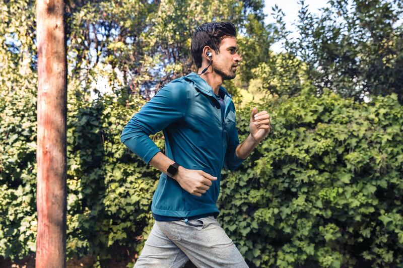 Lifestyle photo of young man jogging outside