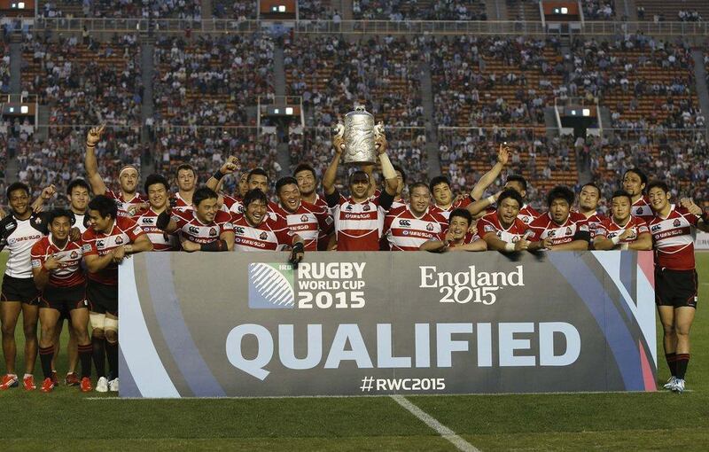 Japan rugby captain Michael Leitch lifts the Asian Five Nations trophy after their victory, which qualified them for the 2015 Rugby World Cup, over Hong Kong on Sunday. Yuya Shino / Reuters / May 25, 2014