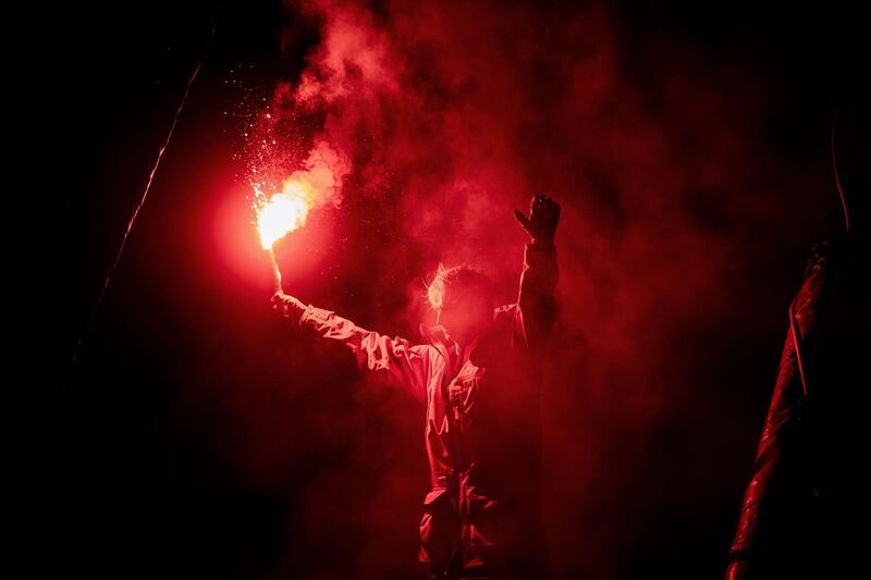 French skipper Maxime Sorel holds a red flare as he celebrates onboard his Imoca 60 monohull "V&B - Mayenne" after crossing the finish line of the Vendee Globe round-the-world solo sailing race, at Les Sables-d'Olonne, western France. Sorel placed tenth. AFP