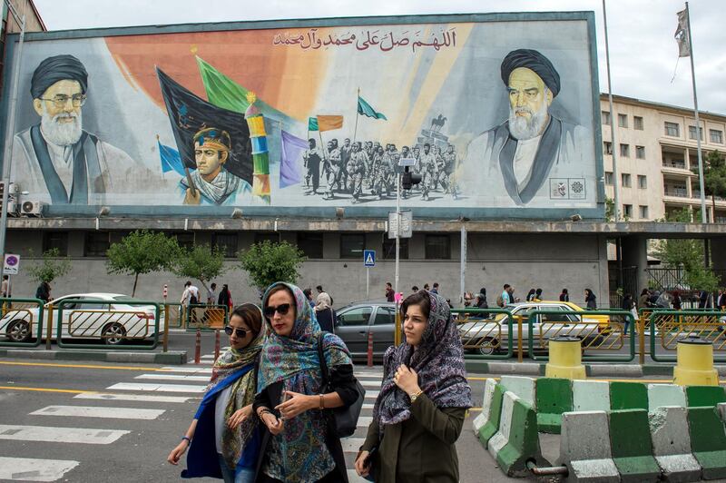 Women cross a street near a giant political mural depicting Ayatollah Ali Khamenei, Iran's supreme leader, left, and Ruhollah Khomeini, founder of the Islamic republic of Iran, in Tehran, Iran, on Wednesday, May 9, 2018. U.S. President Donald Trump pulled out of the 2015 deal that put limits on Iran’s nuclear program in exchange for rapprochement with the West. Photographer: Ali Mohammadi/Bloomberg