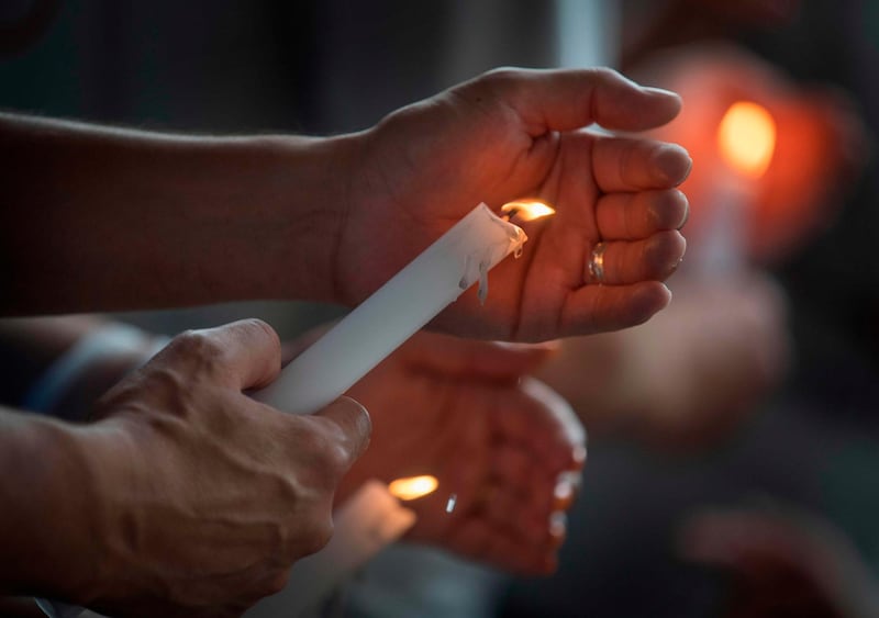 People light candles during a prayer and candle vigil organized by the city, after the shooting that left 20 people dead at the Cielo Vista Mall WalMart in El Paso, Texas, on August 4, 2019. The United States mourned Sunday for victims of two mass shootings that killed 29 people in less than 24 hours as debate raged over whether President Donald Trump's rhetoric was partly to blame for surging gun violence. The rampages turned innocent snippets of everyday life into nightmares of bloodshed: 20 people were shot dead while shopping at a crowded Walmart in El Paso, Texas on Saturday morning, and nine more outside a bar in a popular nightlife district in Dayton, Ohio just 13 hours later.
 / AFP / Mark RALSTON

