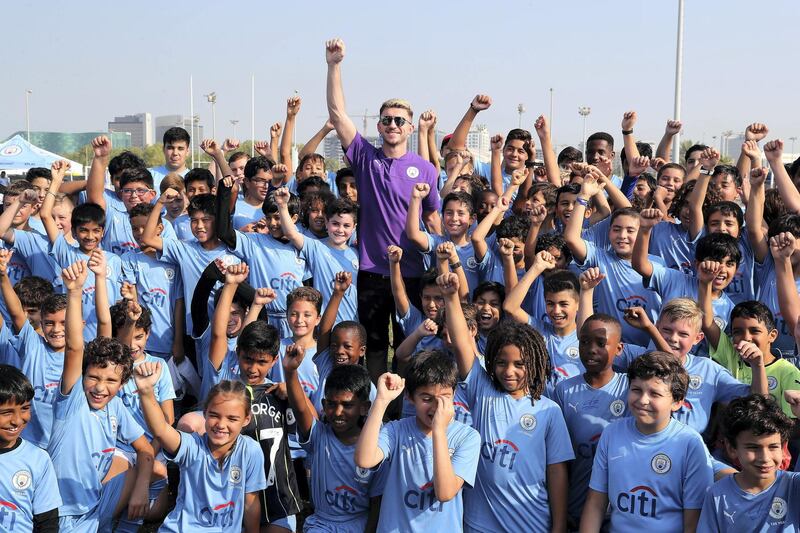 ABU DHABI, UNITED ARAB EMIRATES , Nov 30 – 2019 :- Aymeric Laporte, French footballer posing for the photo with the students of Manchester City football school Abu Dhabi at the Zayed Sports city in Abu Dhabi. ( Pawan Singh / The National )  For Sports. Story by Jon Turner 