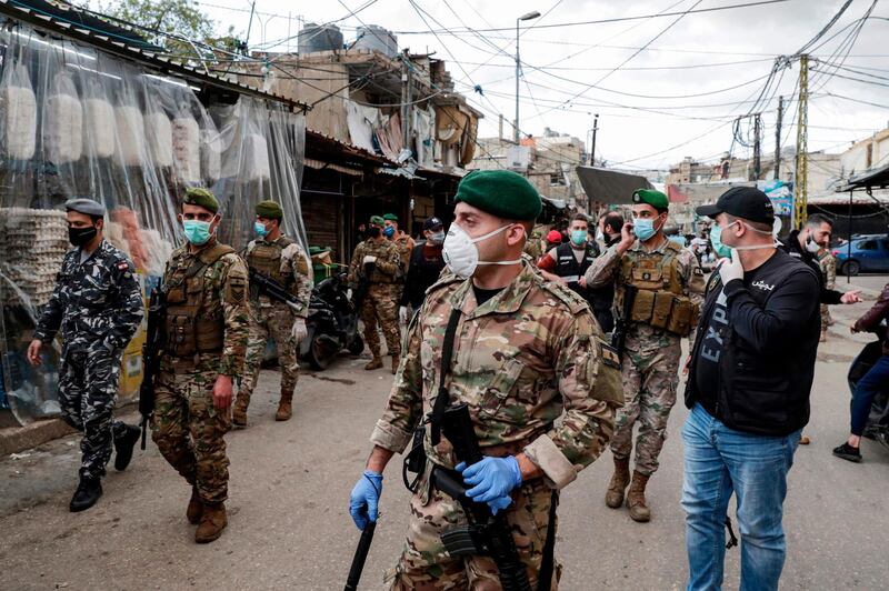 Lebanese army soldiers patrol in the market of the Palestinian refugee camp of Sabra, south of the capital Beirut, as measures coordinated with Palestinian security forces were taken to shut down all shops in a bid to limit the spread of Covid-19.  AFP