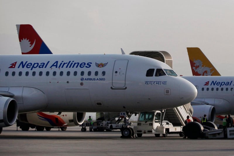 Nepal Airlines Airbus 320 and other international airlines are seen parked inside Tribhuwan International airport in Kathmandu, Nepal, Monday, Nov. 9, 2015. Airlines in Nepal have been forced to cancel more than half of their domestic flights because of an ongoing fuel shortage, an official said Monday. (AP Photo/Niranjan Shrestha)