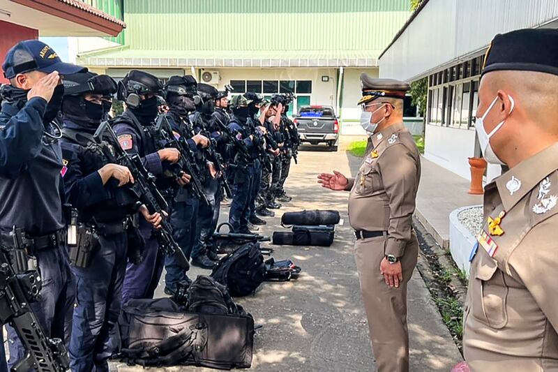 Police are briefed after the mass shooting. AFP