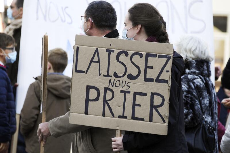 A Catholic believer holds a sign reading 'Allow us to pray' as she takes part in a rally in Strasbourg, eastern France, against a ban on the celebration of masses due to coronavirus restrictions. AFP