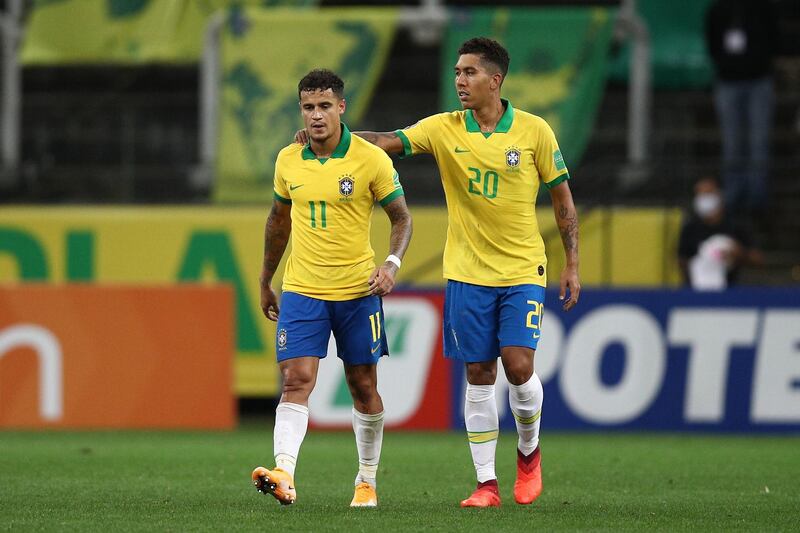 Philippe Coutinho of Brazil celebrates with Roberto Firmino after scoring the fifth goal. Getty