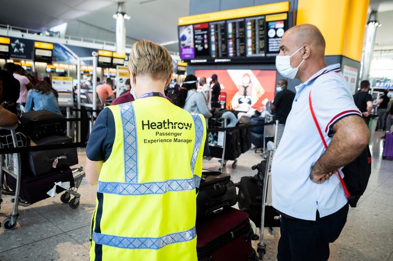 A passenger with a member of staff at Heathrow. The easing of UK travel restrictions led to rising demand for air travel but levels are still well below those of 2019.