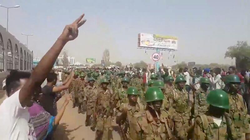 Demonstrators salute soldiers during a protest in Khartoum, Sudan April 10, 2019 in this still image taken from a video obtained from social media. TWITTER/@THAWRAGYSD/via REUTERS  ATTENTION EDITORS - THIS IMAGE HAS BEEN SUPPLIED BY A THIRD PARTY. MANDATORY CREDIT.