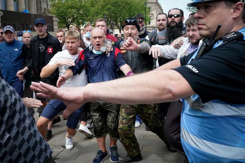 BOLTON, UNITED KINGDOM - JUNE 13: Black Lives Matter protesters counter demonstrators face off with each other at the Cenotaph during a Black Lives Matter protest on June 13, 2020 in Bolton, England. A number of anti-racism protesters have gathered for protests in the UK despite the cancellation of the official events due to fears of clashes with far-right groups. Following a social media post by the far-right activist known as Tommy Robinson, members of far-right linked groups have gathered around statues in London, which have been targeted by Black Lives Matter protesters for their links to racism and the slave trade. (Photo by Christopher Furlong/Getty Images)