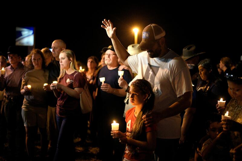 Ramiro and Sofia Martinez attend a candle light vigil after a mass shooting at the First Baptist Church in Sutherland Springs, Texas, U.S., November 5, 2017.   REUTERS/Sergio Flores