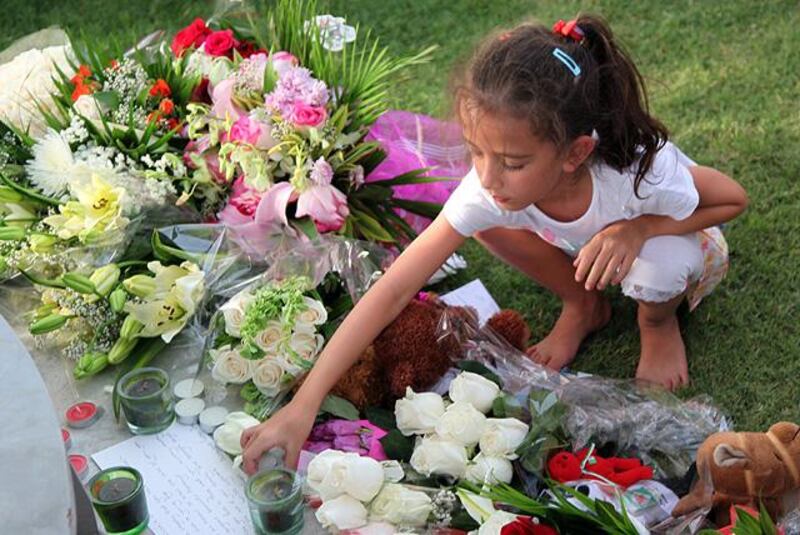 A girl outs a candle as mourners gather at the "Aspire Zone" close to the scene where two-year-old New Zealand triplets among 19 others perished in a massive fire that tore through a nursery at a Qatar shopping mall  in Doha on May 29, 2012. Qatar started burying or repatriating the 19 victims of a massive fire that tore through a nursery at Vellagio mall, as investigators scoured for clues to the cause of the blaze that killed 13 children, including the New Zealand triplets. AFP PHOTO/STR

