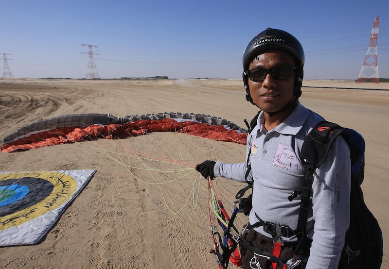 ABU DHABI - UNITED ARAB EMIRATES - 16FEB2013 - Marazmizal Omar paraglider packs after making a spot landing from a 600m-high manmade hill at Al Wathba area outside Abu Dhabi. Ravindranath K / The National