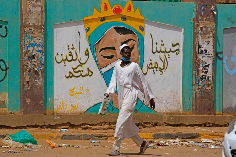 A man walks by a mural dedicated to health workers in the Sudanese capital's twin city of Omdurman. AFP