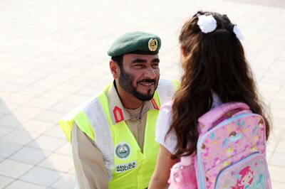 Maj Gen Al Ghaithi, director of the General Department of Protective Security and Emergency at Dubai Police, greets a young pupil at the School of Research Science. Chris Whiteoak / The National