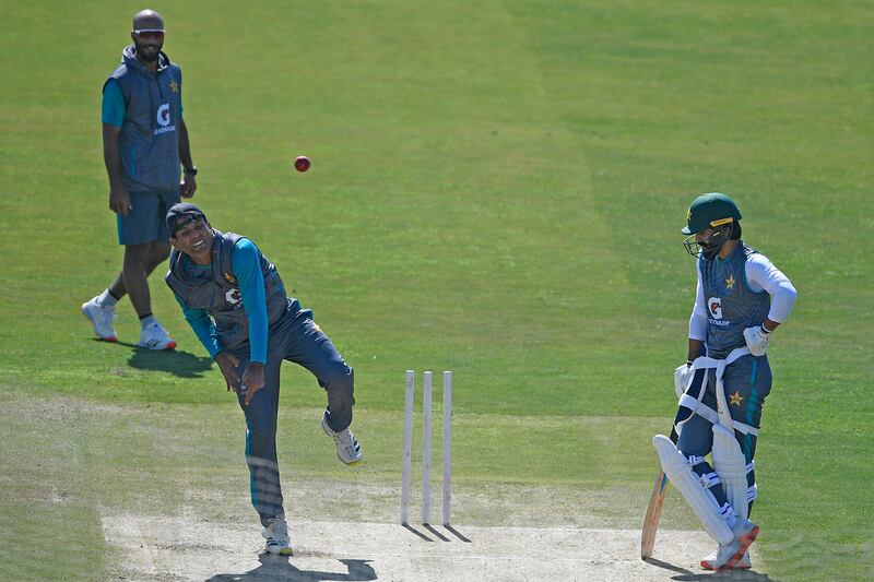 Pakistan's Nauman Ali bowls as teammates Fawad Alam, right, and Sajid Khan watch during a practice session at the Rawalpindi Cricket Stadium on Sunday. AFP