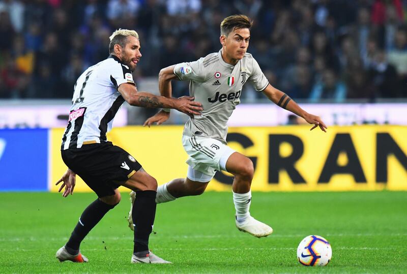 Dybala competes for the ball with Valon Behrami of Udinese Calci. Getty Images