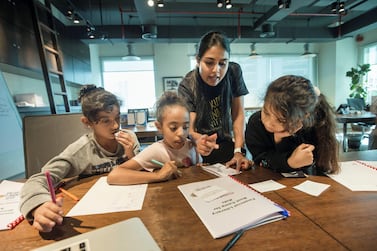 Mishael Al Shamsi, 9, Mariam El Tohamy, 8, and Lama Al Khouri, 10, learn how to spend and save money wisely at a financial literacy boot camp run by The Kids Finance Initiative. Leslie Pableo / The National