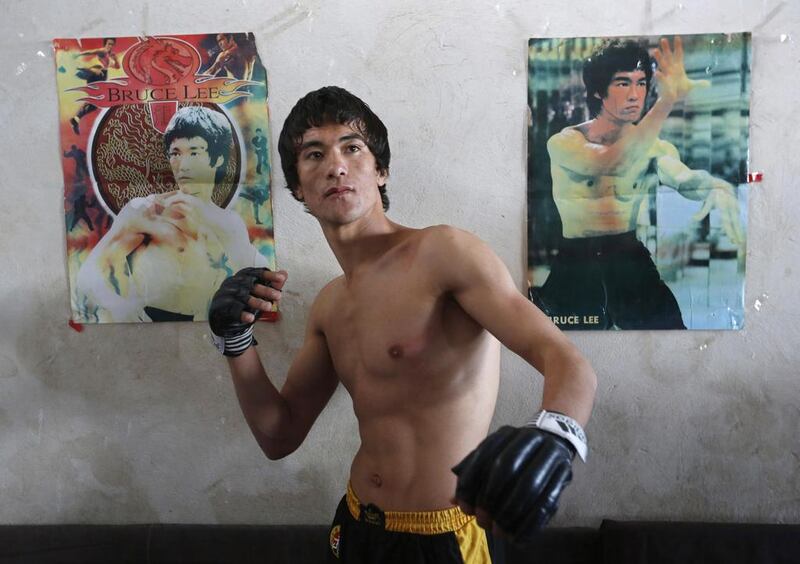 “I want to be a champion in my country and a Hollywood star,” Alizada says at Kabul’s desolate Darul Aman Palace, where he trains twice a week, swirling nunchakus and sporting a Lee-like bowl haircut. Mohammad Ismail / Reuters 