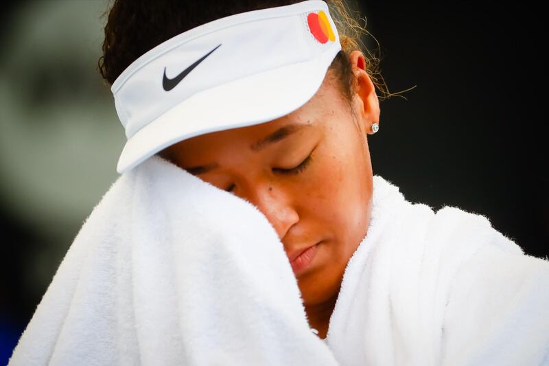 Naomi Osaka uses her towel during Day Two of the Brisbane International. AFP