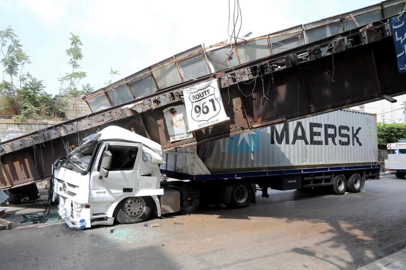 A Lebanese truck lies crushed under a bridge in Beirut’s Mar Mikhail neighbourhood.  AFP