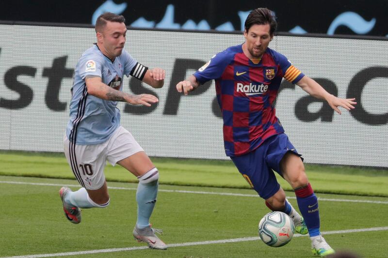 Barcelona's Lionel Messi, right, under pressure from Iago Aspas of Celta Vigo. AP