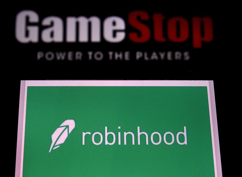 (FILES) In this file photo illustration taken on January 28, 2021, shows the logos of video grame retail store GameStop and trading application Robinhood in a computer and on a mobile phone in Arlington, Virginia. Key players involved in the trading frenzy centered on GameStop shares told skeptical US lawmakers on February 18, 2021 that their actions were above board and in line with ordinary stockmarket business. Founders of free stock-trading app Robinhood and online forum Reddit were among those to testify at a House of Representatives financial services committee hearing.
 / AFP / Olivier DOULIERY
