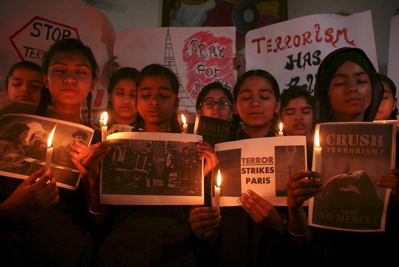 Schoolgirls in Amritsar, India, hold candles and posters as they pray during a vigil to show solidarity with the victims of the Paris attacks on November 16, 2015. Munish Sharma / Reuters