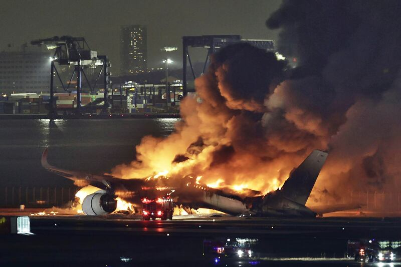 The Japan Airlines plane burns out on the runway at Haneda Airport in Tokyo. AP