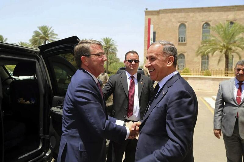 US defence aecretary Ash Carter, left, shakes hands with Iraqi defence minister Khaled Al Obeidi at the defence ministry in Baghdad. AP Photo